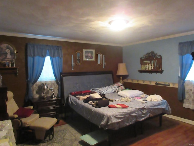 bedroom featuring wood-type flooring and ornamental molding