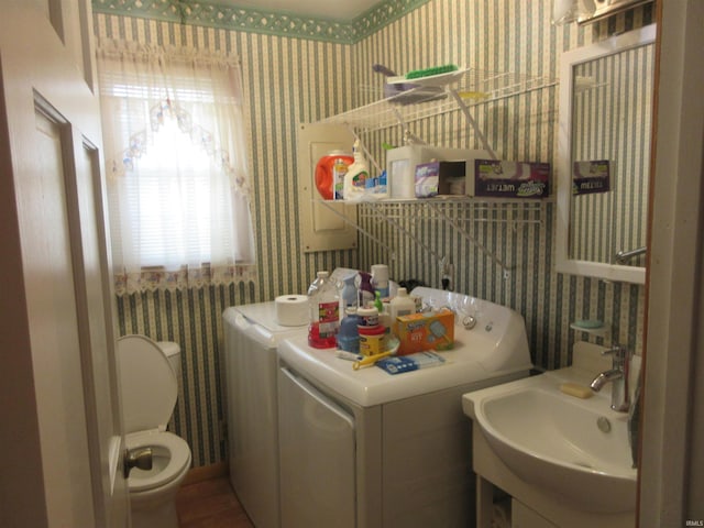 clothes washing area with sink and washing machine and clothes dryer