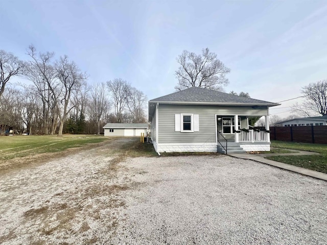 view of front of property featuring covered porch and a front yard