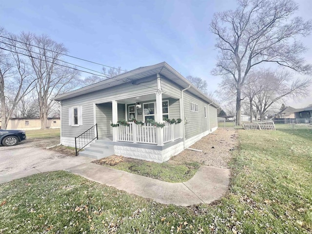 view of front of house with covered porch and a front yard