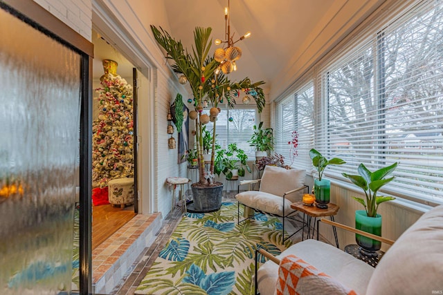 sunroom / solarium with lofted ceiling and a notable chandelier