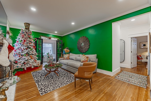 living room with hardwood / wood-style flooring and ornamental molding