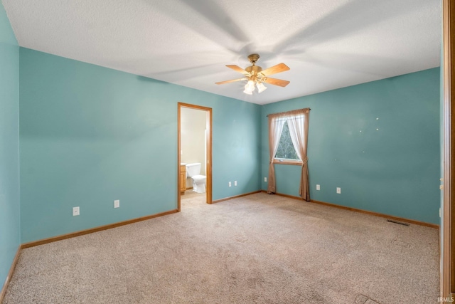 carpeted empty room with ceiling fan and a textured ceiling