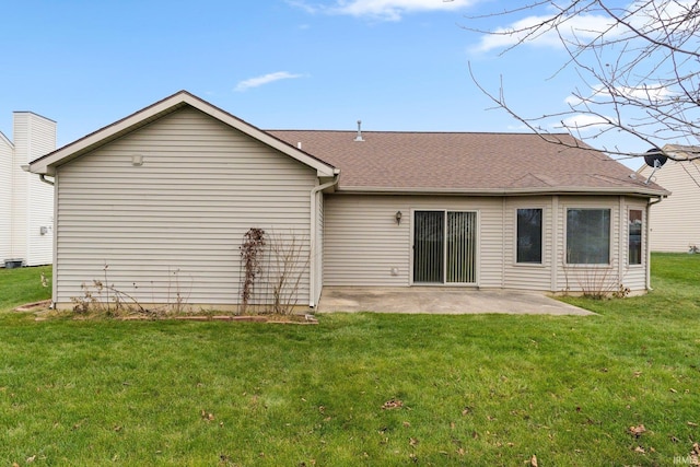 rear view of property with a lawn and a patio