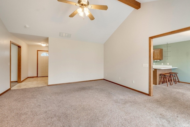 interior space featuring vaulted ceiling with beams, ceiling fan, and light colored carpet