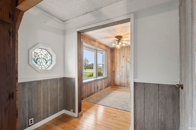 interior space with wood walls and hardwood / wood-style floors