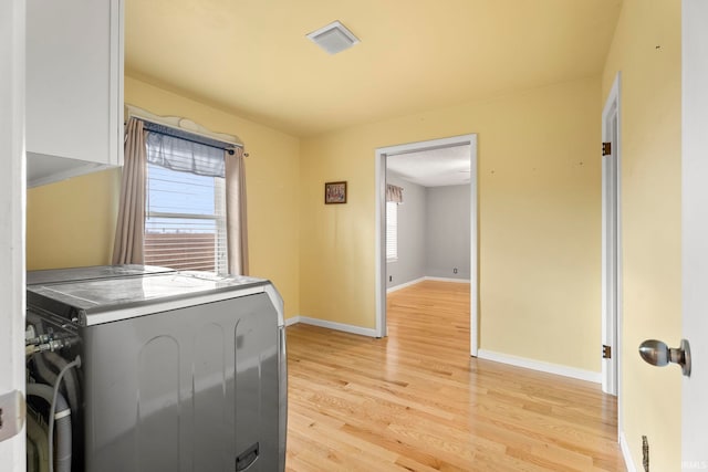 laundry room featuring light hardwood / wood-style floors and washing machine and clothes dryer