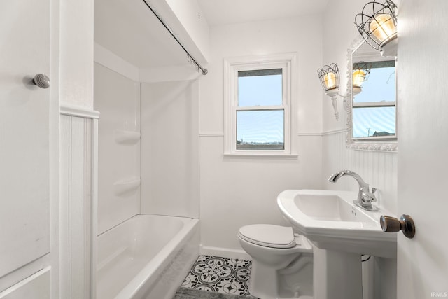 bathroom with tile patterned flooring,  shower combination, and toilet