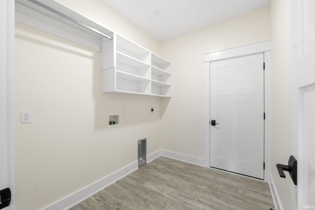 washroom featuring washer hookup, electric dryer hookup, and light wood-type flooring