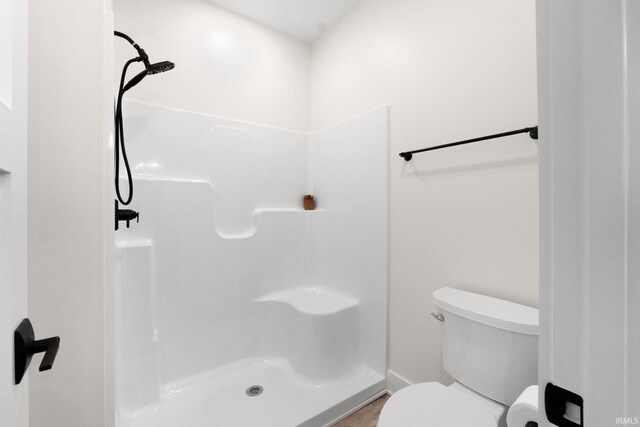 bathroom with toilet and walk in shower