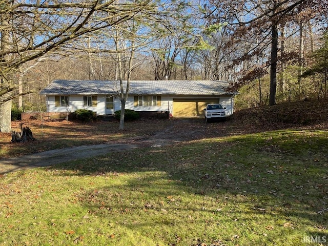 exterior space featuring a lawn and a garage