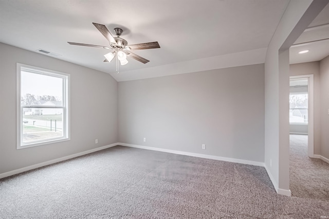 carpeted spare room with plenty of natural light and ceiling fan