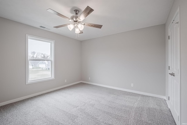 spare room with ceiling fan and carpet floors