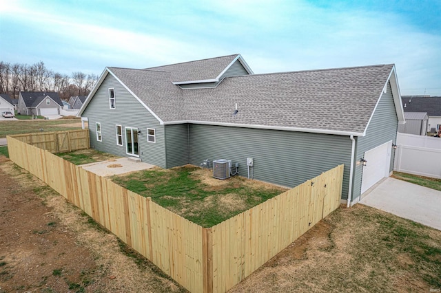 view of side of home with central AC