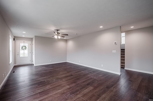 unfurnished living room with dark hardwood / wood-style floors and ceiling fan