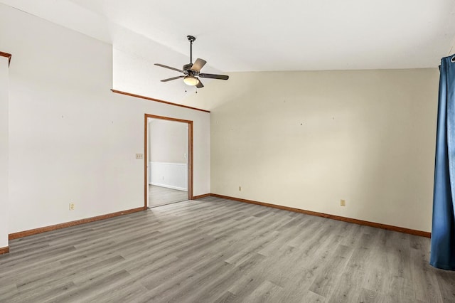 empty room featuring light hardwood / wood-style flooring, ceiling fan, and lofted ceiling