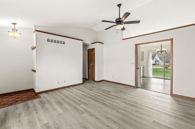 spare room featuring a textured ceiling, ceiling fan with notable chandelier, light hardwood / wood-style floors, and vaulted ceiling