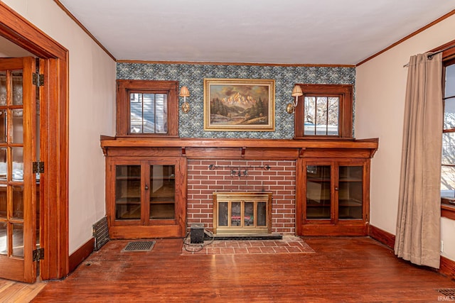 unfurnished living room featuring a fireplace, hardwood / wood-style flooring, and crown molding