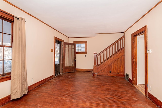 foyer featuring dark hardwood / wood-style flooring, plenty of natural light, and ornamental molding