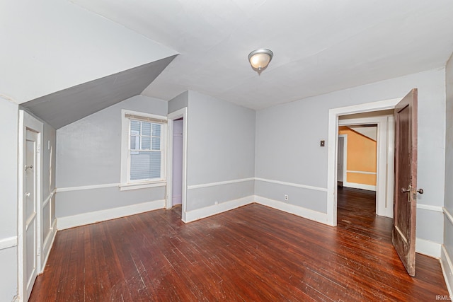 bonus room with dark hardwood / wood-style floors and lofted ceiling