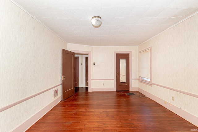 unfurnished room featuring dark hardwood / wood-style floors and ornamental molding