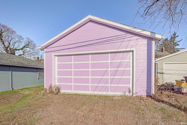 garage featuring a lawn