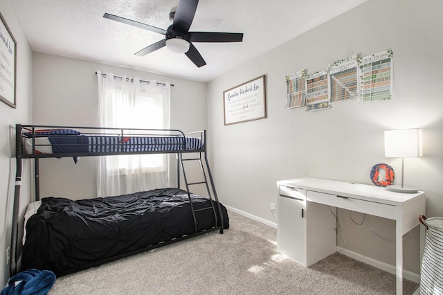 bedroom with a textured ceiling, ceiling fan, and light carpet