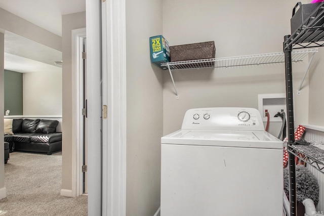 laundry area featuring light carpet and washer / clothes dryer