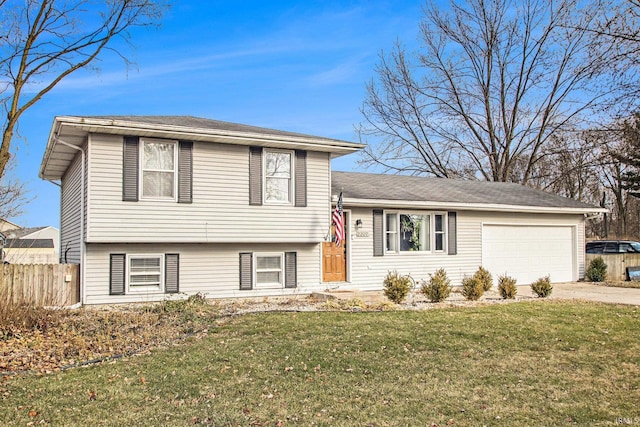 tri-level home with a front yard and a garage