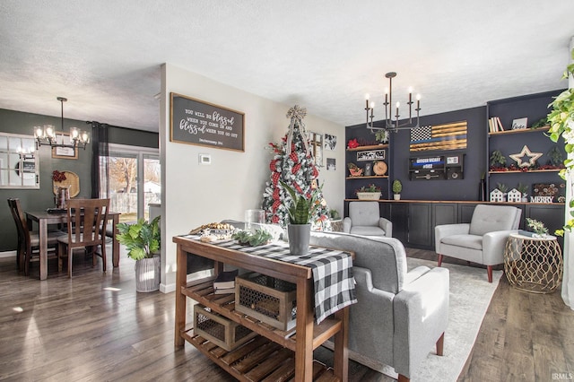 living room featuring hardwood / wood-style flooring, a textured ceiling, and an inviting chandelier