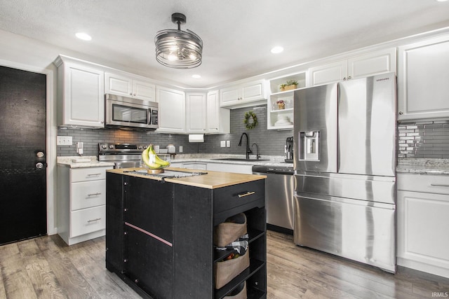 kitchen featuring dark hardwood / wood-style flooring, sink, white cabinetry, and stainless steel appliances