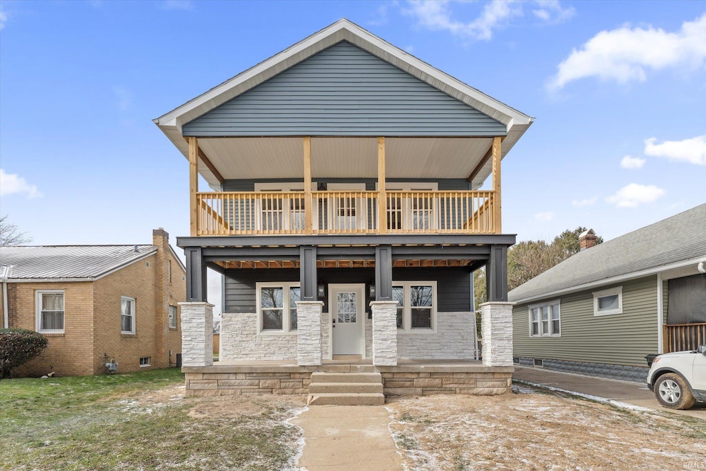 view of front of property featuring covered porch and a balcony