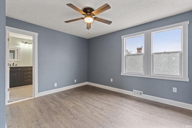 spare room with light hardwood / wood-style flooring and ceiling fan