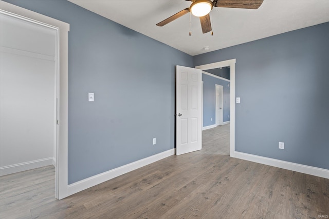 unfurnished bedroom with a closet, light hardwood / wood-style floors, and ceiling fan