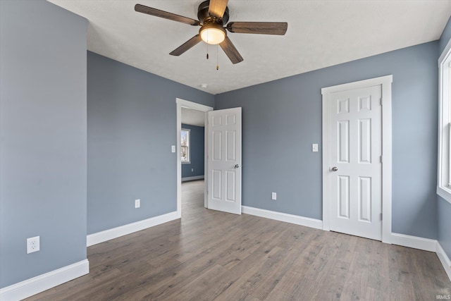 unfurnished bedroom with hardwood / wood-style floors, a textured ceiling, and ceiling fan