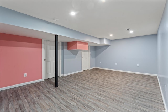 basement with light hardwood / wood-style floors