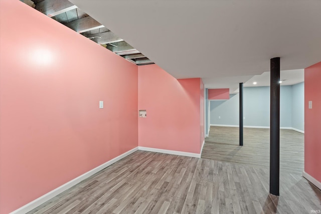 basement with light hardwood / wood-style floors