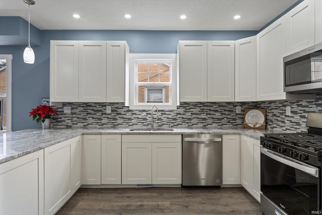 kitchen featuring white cabinets, dark hardwood / wood-style flooring, sink, and appliances with stainless steel finishes