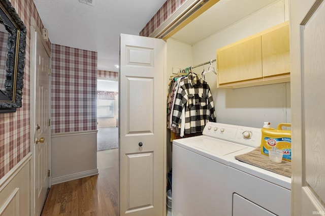 laundry area featuring wood-type flooring, a textured ceiling, and independent washer and dryer