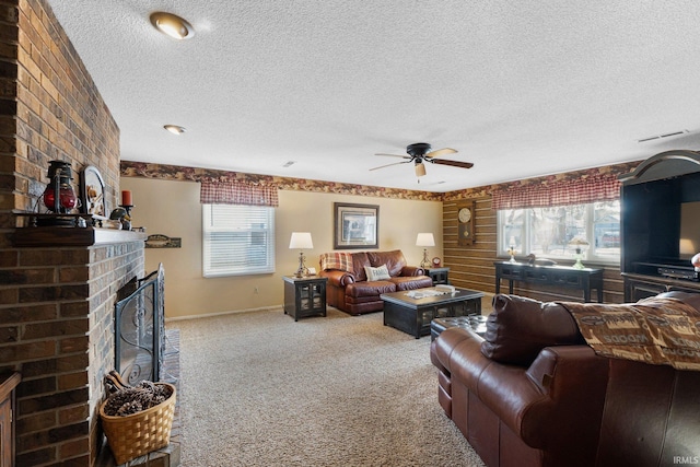 living room with a textured ceiling, light colored carpet, a wealth of natural light, and ceiling fan