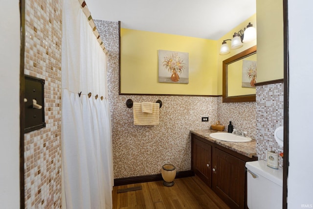 bathroom with vanity, hardwood / wood-style flooring, and toilet