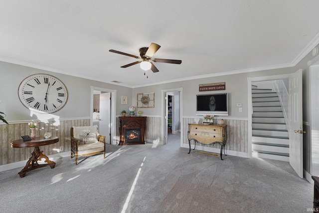 unfurnished room featuring carpet, a textured ceiling, crown molding, and wooden walls