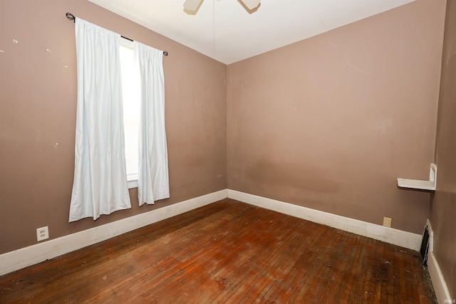 spare room featuring ceiling fan and dark hardwood / wood-style flooring