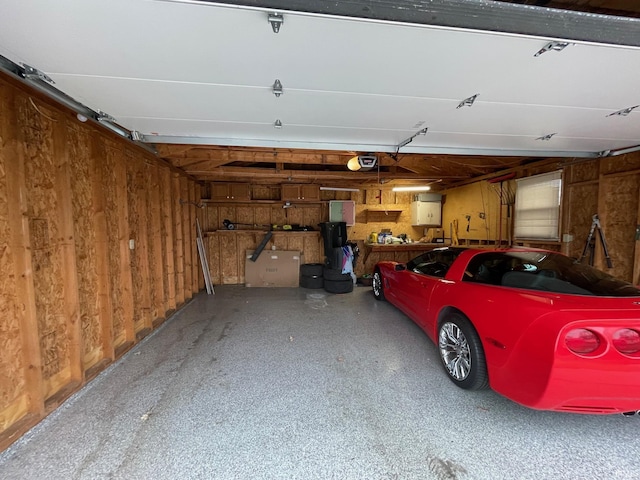 garage featuring wood walls and a garage door opener