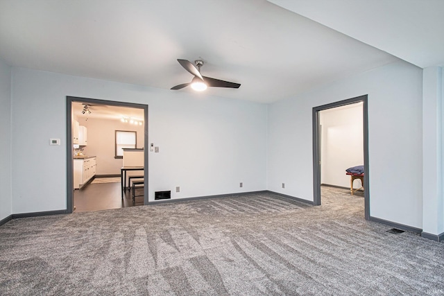 carpeted empty room featuring ceiling fan