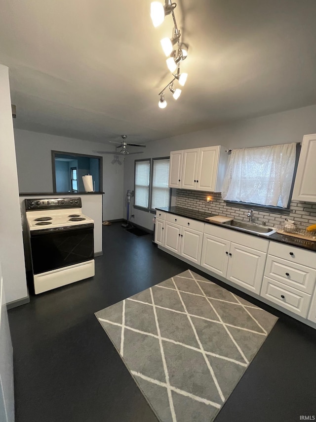 kitchen with backsplash, sink, electric range, ceiling fan, and white cabinetry