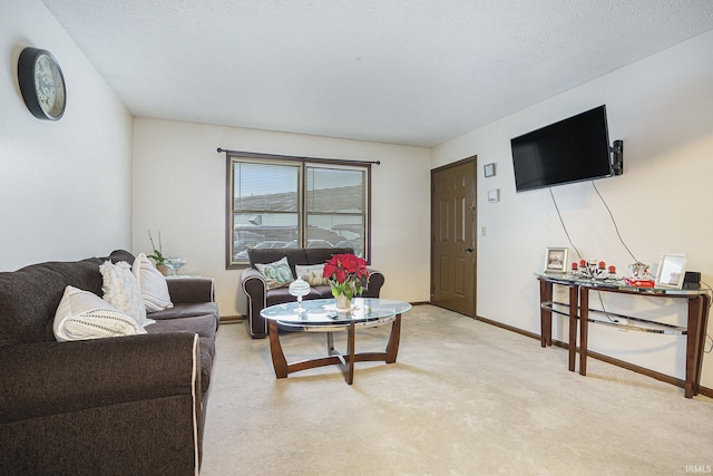 carpeted living room featuring a textured ceiling