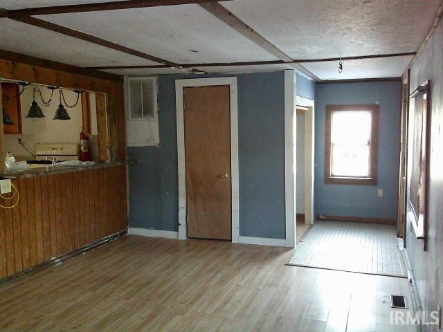 interior space featuring hardwood / wood-style flooring and a textured ceiling