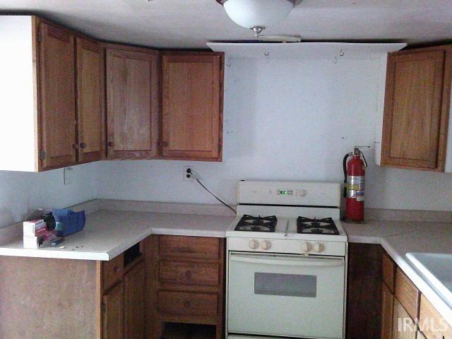 kitchen featuring white range with gas cooktop