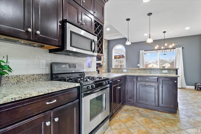 kitchen featuring light stone countertops, tasteful backsplash, decorative light fixtures, kitchen peninsula, and stainless steel appliances